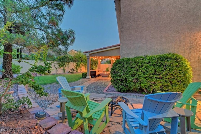 4651 Munich Ct, Las Vegas, NV 89147 - fenced backyard featuring a patio and an outdoor fire pit