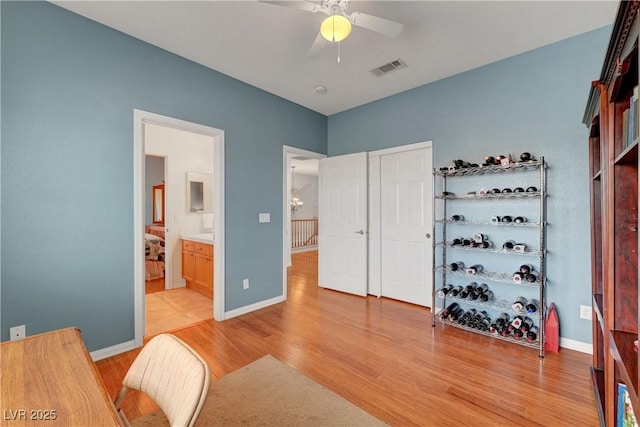 4651 Munich Ct, Las Vegas, NV 89147 - home office with light wood finished floors and ceiling fan