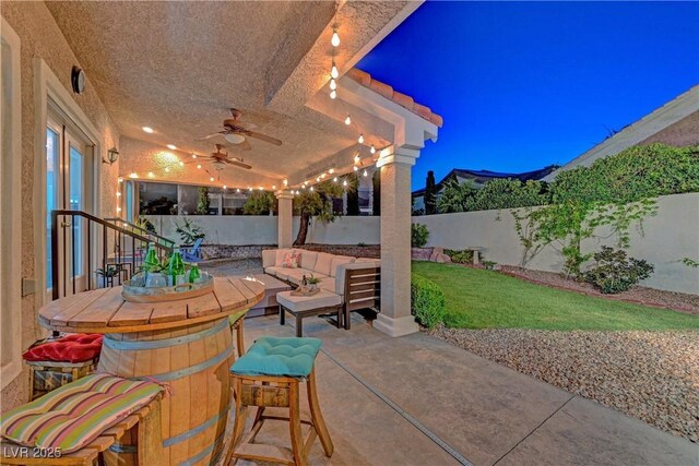 4651 Munich Ct, Las Vegas, NV 89147 - fenced backyard with outdoor lounge area, a patio, and ceiling fan