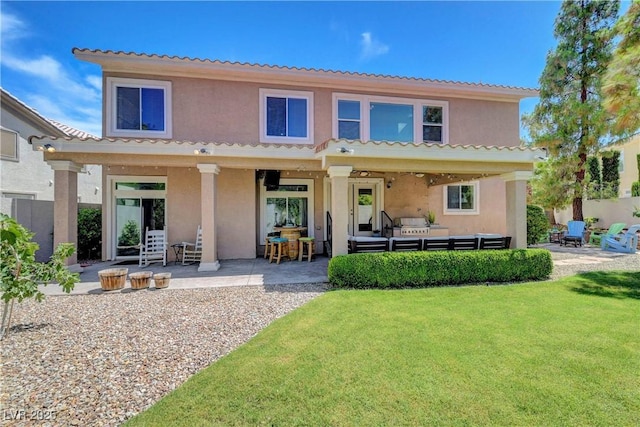4651 Munich Ct, Las Vegas, NV 89147 - back of property featuring stucco siding, an outdoor living space, a patio area, a lawn, and a tiled roof