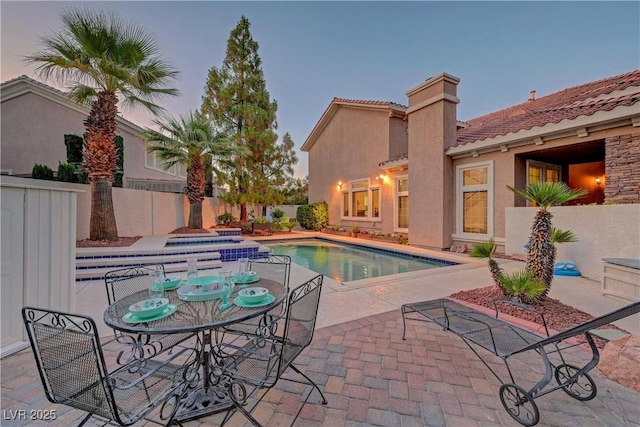4651 Munich Ct, Las Vegas, NV 89147 - pool at dusk featuring a patio area and a pool with connected hot tub