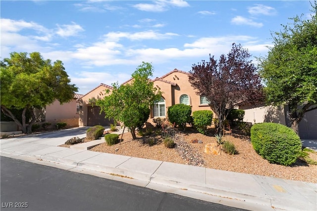 12276 Caminita Pl, Las Vegas, NV 89138 - view of front of property with a garage, driveway, stucco siding, and a tiled roof