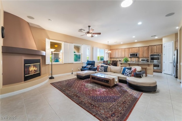 12276 Caminita Pl, Las Vegas, NV 89138 - living area featuring light tile patterned flooring, ceiling fan, a large fireplace, and recessed lighting