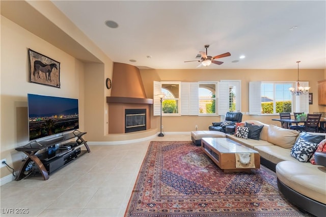 12276 Caminita Pl, Las Vegas, NV 89138 - living room featuring a large fireplace, tile patterned floors, a chandelier, ceiling fan, and recessed lighting