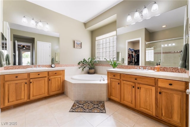 12276 Caminita Pl, Las Vegas, NV 89138 - full bathroom featuring vanity, a shower stall, tile patterned floors, and a bath