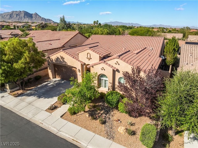 12276 Caminita Pl, Las Vegas, NV 89138 - mediterranean / spanish-style house with a tiled roof, a garage, stucco siding, concrete driveway, and a mountain view
