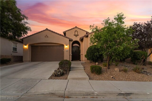 12276 Caminita Pl, Las Vegas, NV 89138 - mediterranean / spanish house featuring a garage, driveway, stucco siding, and a tiled roof