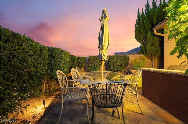 12276 Caminita Pl, Las Vegas, NV 89138 - patio terrace at dusk with outdoor dining space