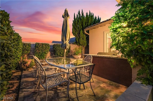 12276 Caminita Pl, Las Vegas, NV 89138 - patio terrace at dusk with outdoor dining area and a patio
