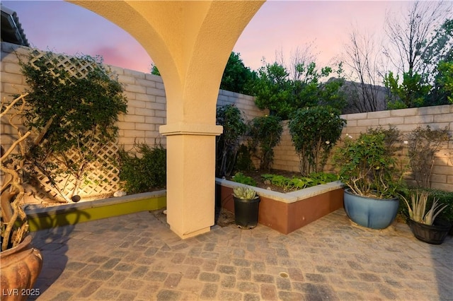12276 Caminita Pl, Las Vegas, NV 89138 - patio terrace at dusk featuring a fenced backyard and a patio area