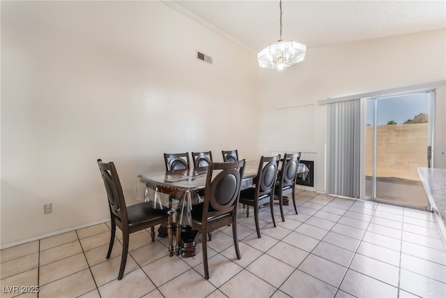 6224 Mandarin Dr, Las Vegas, NV 89108 - dining area featuring light tile patterned floors, a chandelier, and high vaulted ceiling