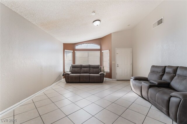 6224 Mandarin Dr, Las Vegas, NV 89108 - living room featuring vaulted ceiling, a textured ceiling, and light tile patterned flooring