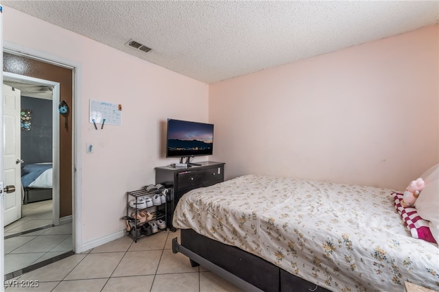 6224 Mandarin Dr, Las Vegas, NV 89108 - bedroom featuring light tile patterned floors and a textured ceiling