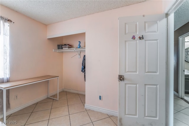 6224 Mandarin Dr, Las Vegas, NV 89108 - unfurnished bedroom featuring a textured ceiling, light tile patterned floors, and a closet