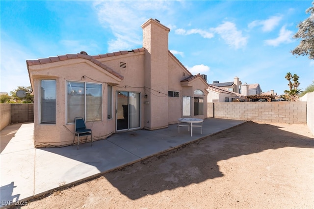 6224 Mandarin Dr, Las Vegas, NV 89108 - back of house with a patio area, a fenced backyard, stucco siding, and a chimney