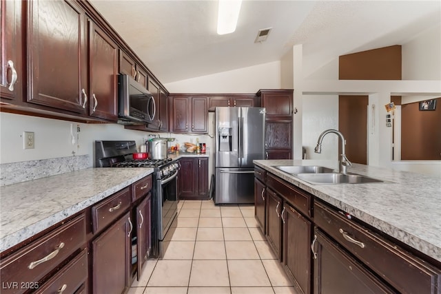 6224 Mandarin Dr, Las Vegas, NV 89108 - kitchen with stainless steel appliances, vaulted ceiling, light countertops, light tile patterned flooring, and dark brown cabinetry