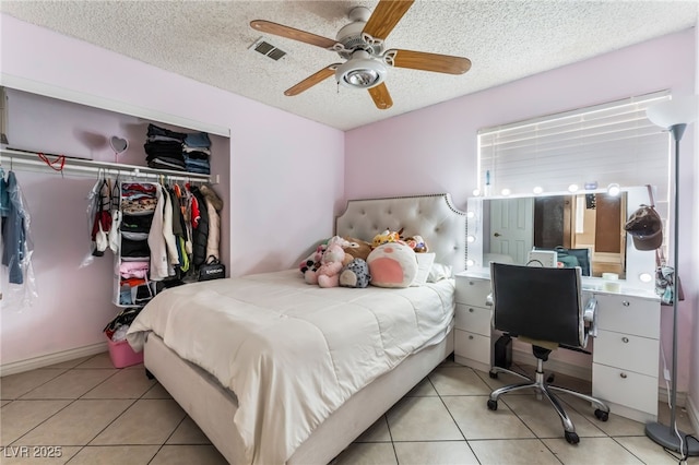 6224 Mandarin Dr, Las Vegas, NV 89108 - bedroom with tile patterned floors, a textured ceiling, a closet, ceiling fan, and a desk