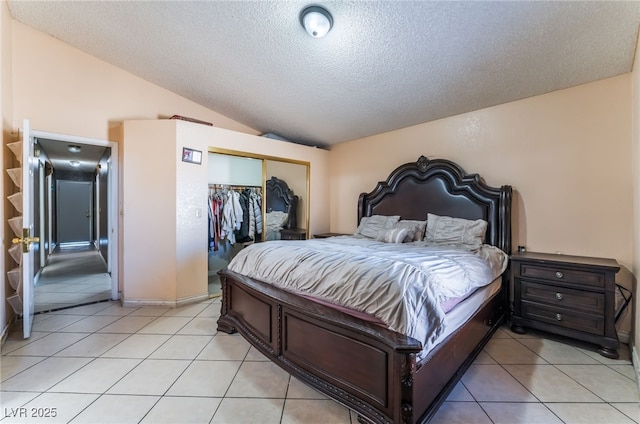 6224 Mandarin Dr, Las Vegas, NV 89108 - bedroom with a textured ceiling, a closet, lofted ceiling, and light tile patterned floors
