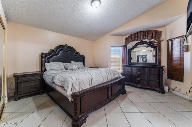 6224 Mandarin Dr, Las Vegas, NV 89108 - bedroom featuring vaulted ceiling, a textured ceiling, and light tile patterned flooring
