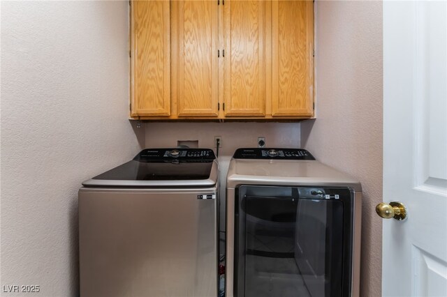 6224 Mandarin Dr, Las Vegas, NV 89108 - laundry area featuring washing machine and clothes dryer, cabinet space, and a textured wall