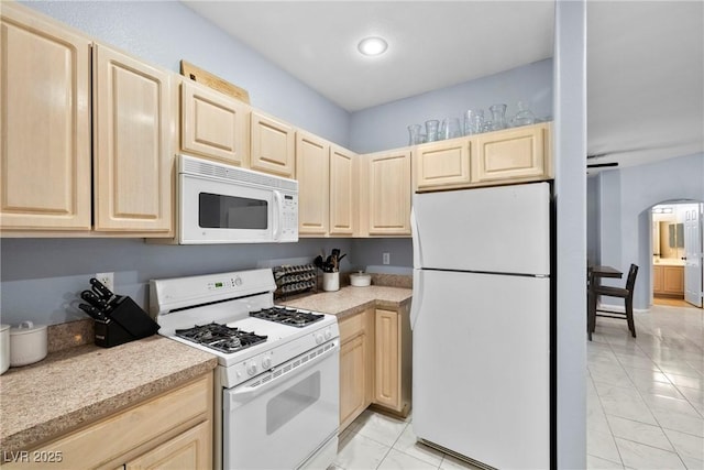 109 Breezy Tree Ct Unit 202, Las Vegas, NV 89145 - kitchen featuring white appliances, light brown cabinets, arched walkways, light countertops, and recessed lighting