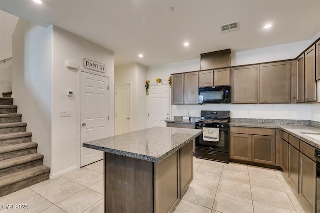 1200 Mission View Ct, Henderson, NV 89002 - kitchen with black appliances, light tile patterned floors, stone countertops, a kitchen island, and recessed lighting