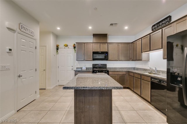 1200 Mission View Ct, Henderson, NV 89002 - kitchen featuring black appliances, a center island, light tile patterned floors, light stone counters, and recessed lighting