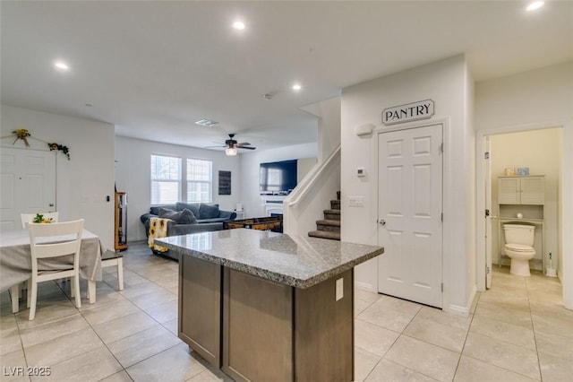 1200 Mission View Ct, Henderson, NV 89002 - kitchen with light tile patterned floors, a center island, recessed lighting, ceiling fan, and light stone counters