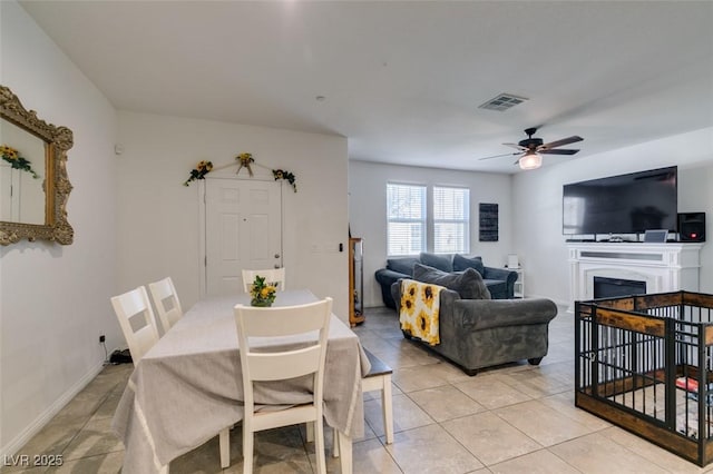 1200 Mission View Ct, Henderson, NV 89002 - dining area with a ceiling fan, light tile patterned flooring, and a fireplace