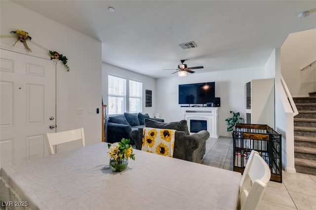 1200 Mission View Ct, Henderson, NV 89002 - dining area featuring stairs, a ceiling fan, light tile patterned floors, and a glass covered fireplace