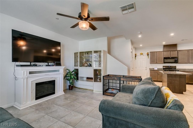 1200 Mission View Ct, Henderson, NV 89002 - living area with a ceiling fan, light tile patterned floors, recessed lighting, and a glass covered fireplace