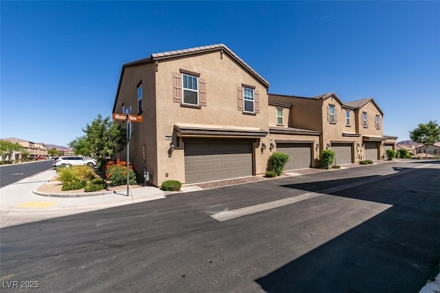 1200 Mission View Ct, Henderson, NV 89002 - townhome / multi-family property featuring stucco siding, an attached garage, and a residential view