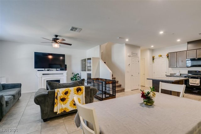1200 Mission View Ct, Henderson, NV 89002 - dining room with light tile patterned floors, stairway, ceiling fan, recessed lighting, and a fireplace