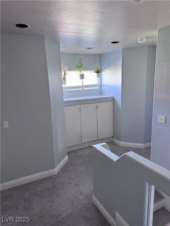 8484 Montana Stream Ave, Las Vegas, NV 89113 - corridor with a textured ceiling and carpet