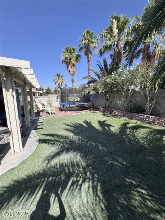 8484 Montana Stream Ave, Las Vegas, NV 89113 - fenced backyard featuring a trampoline
