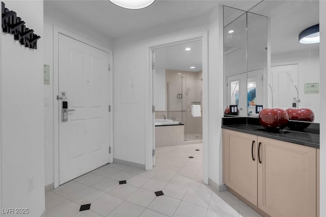 145 E Harmon Ave Unit 3705, Las Vegas, NV 89109 - bathroom featuring a shower stall, vanity, recessed lighting, and tile patterned flooring