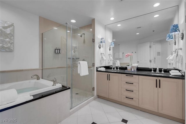 145 E Harmon Ave Unit 3705, Las Vegas, NV 89109 - full bathroom with double vanity, a garden tub, a shower stall, recessed lighting, and tile patterned flooring