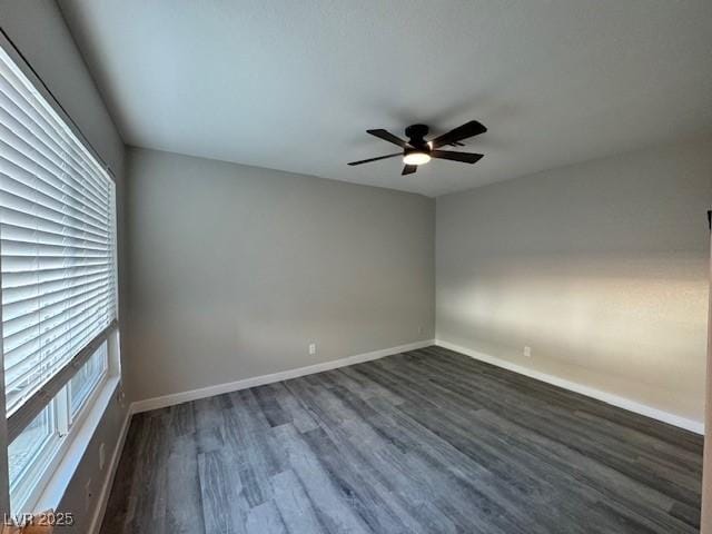 7144 Forest Vista St, Las Vegas, NV 89147 - empty room with healthy amount of natural light, dark wood-type flooring, and ceiling fan