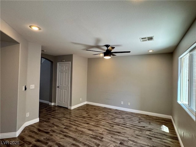 9165 Beauchamp Ave, Las Vegas, NV 89148 - spare room with dark wood finished floors, ceiling fan, arched walkways, recessed lighting, and a textured ceiling