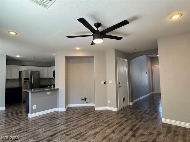 9165 Beauchamp Ave, Las Vegas, NV 89148 - unfurnished living room featuring arched walkways, ceiling fan, dark wood-style flooring, and recessed lighting