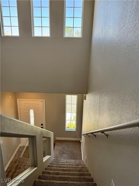 9165 Beauchamp Ave, Las Vegas, NV 89148 - stairway featuring healthy amount of natural light, carpet flooring, and a textured wall