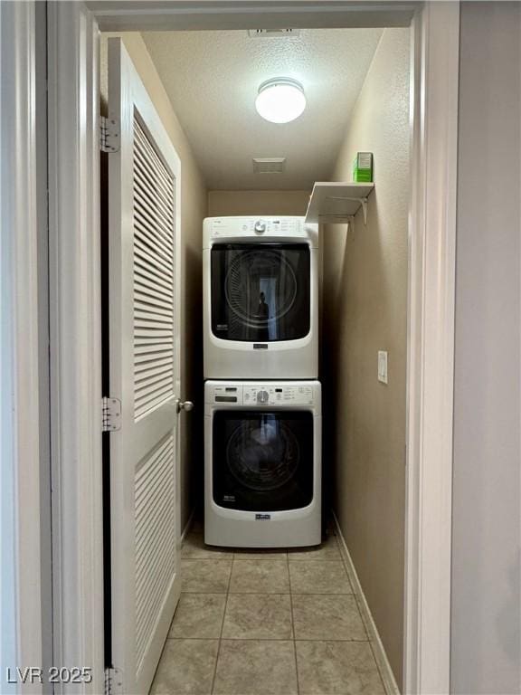 9165 Beauchamp Ave, Las Vegas, NV 89148 - washroom featuring stacked washer / drying machine and light tile patterned floors