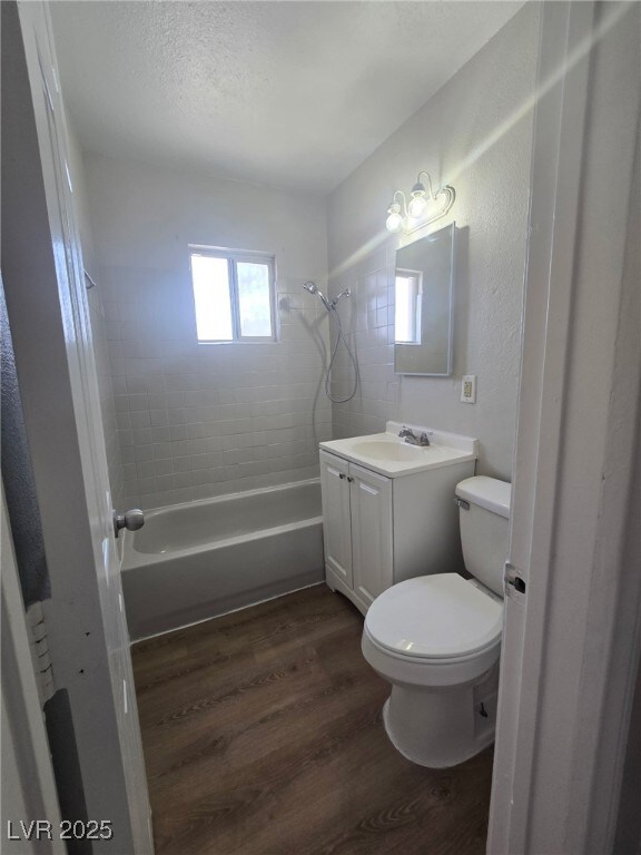 1713 Fairfield Ave, Las Vegas, NV 89102 - bathroom featuring wood finished floors, vanity, and washtub / shower combination