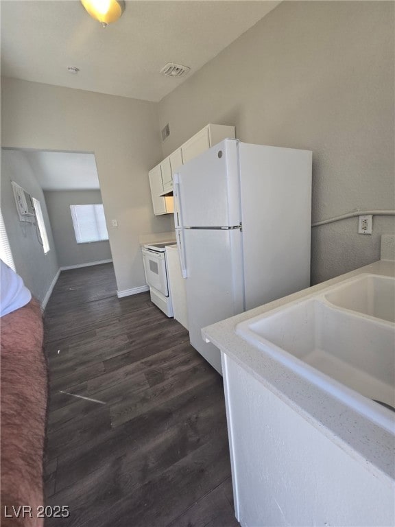 1713 Fairfield Ave, Las Vegas, NV 89102 - kitchen with white appliances, dark wood finished floors, and light countertops