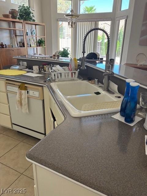 10036 Keysborough Dr, Las Vegas, NV 89134 - kitchen with dishwasher, plenty of natural light, light tile patterned flooring, and a chandelier