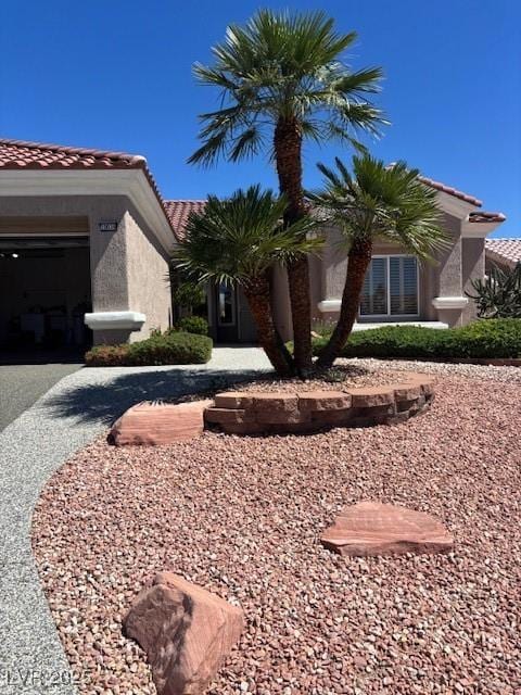 10036 Keysborough Dr, Las Vegas, NV 89134 - view of front facade with a tiled roof, stucco siding, and an attached garage