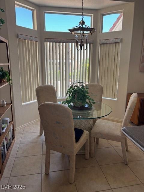 10036 Keysborough Dr, Las Vegas, NV 89134 - dining room with a chandelier, healthy amount of natural light, and light tile patterned floors