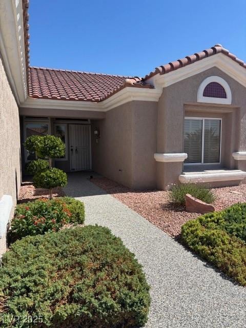 10036 Keysborough Dr, Las Vegas, NV 89134 - view of exterior entry featuring stucco siding and a tile roof