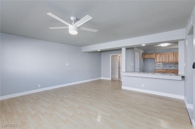 6317 Alta Dr, Las Vegas, NV 89107 - unfurnished living room featuring ceiling fan and light wood-style flooring