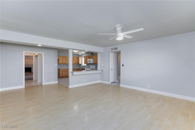 6317 Alta Dr, Las Vegas, NV 89107 - unfurnished living room featuring light wood finished floors and ceiling fan
